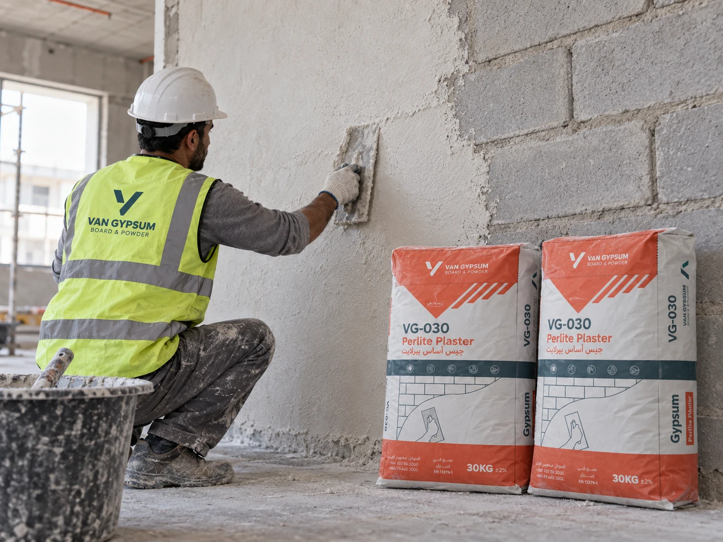 Perlite plaster being applied by hand to an interior masonry wall